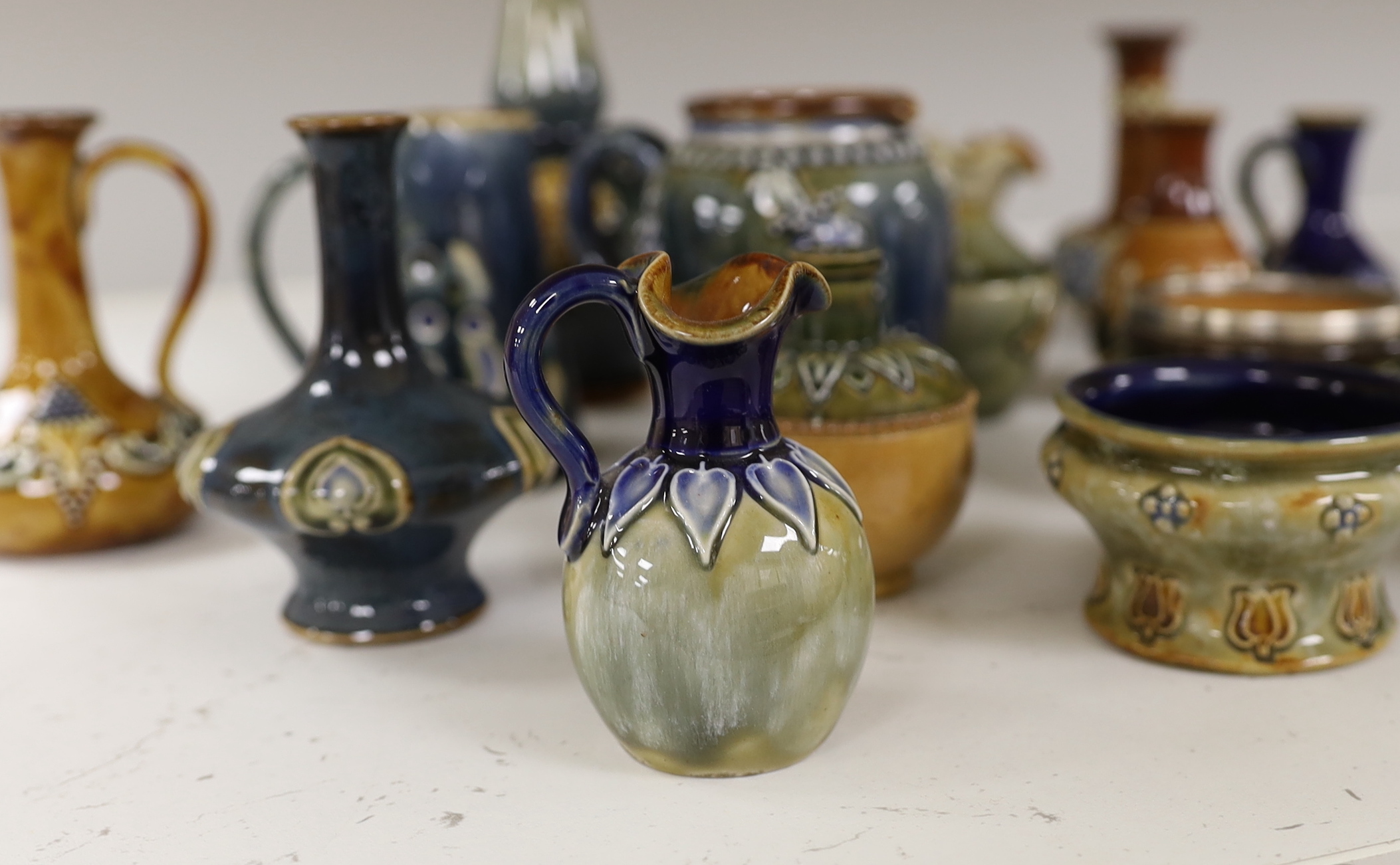Sixteen miniature Doulton Stoneware items including bowls, vases, jugs, etc., tallest, 14.5cm